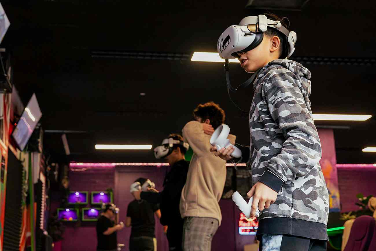 A group of school children playing VR games together