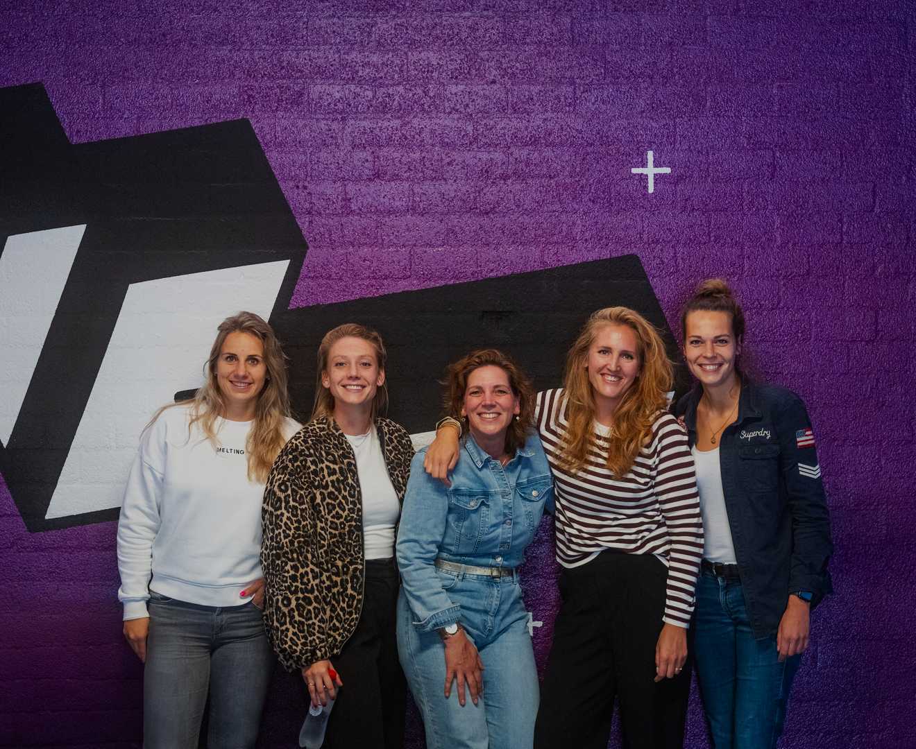 A group of people smiling at the camera after a VR activity